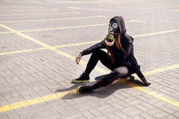 girl in a gas mask fastens a filter box