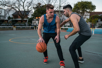 Young basketball players playing one-on-one.