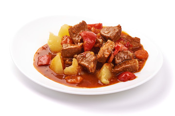 Hungarian goulash, pork stew with potatoes, isolated on white background