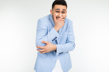 serious man in a jacket joked and laughs on a white studio background