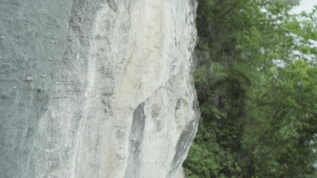 Close up of a hammer tapping rock as prt of drilling bolts