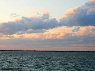 Pink and Yellow Clouds at Sunset over Lake Ocean