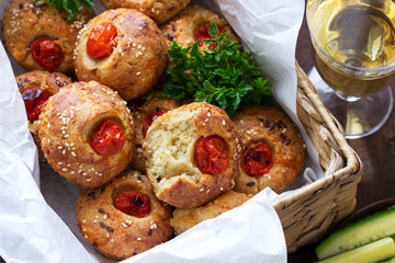 Muffins with cheese, cottage cheese and tomatoes, vegetables and cheese served with wine.