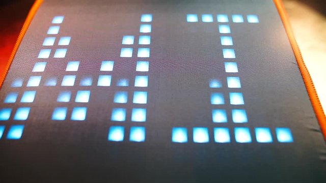 The word submissive is written in pixel moving letters on a gray background at a party. The concept of hierarchical relations.