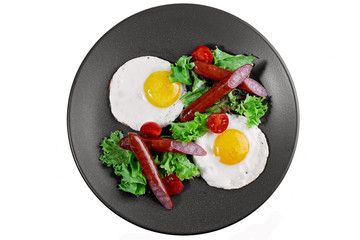 fried eggs with sausage and vegetables
