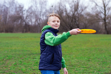 Teenager playing frisbee in the park