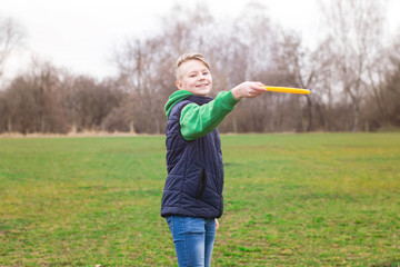 Teenager playing frisbee in the park