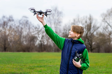 Boy plays with his quadrocopter - Powered by Adobe