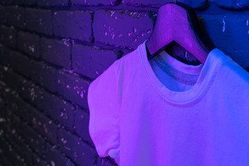 White color unisex t-shirt in neon light , copy space