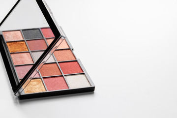 Make up colorful eyeshadow palettes on white, close up