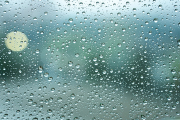rain drops on window glass on blue color