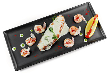 fish baked salmon with sauce on a dark dish