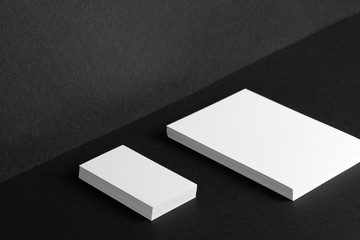 Stacked white businesscards for branding identity on black background, copy space