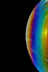 Abstract macro photography.  Close-up of colorful soap bubbles on a black background.