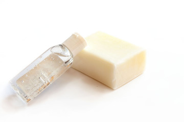 Bar of soap and hand sanitizer alcohol gel - prevention of spreading covid-19, hand washing and disinfection