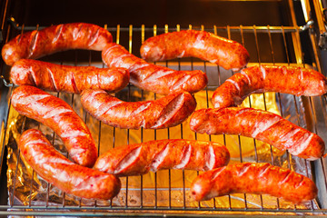 Hot juicy tasty meat sausages just cooked roasted in the kitchen
