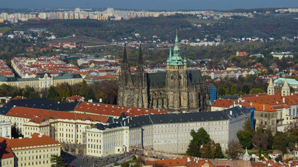 Fototapeta na wymiar Beautiful view of Prague from the highest part of the city. Sunny weather, bright sky and river. Tile roofs glisten in the sun.