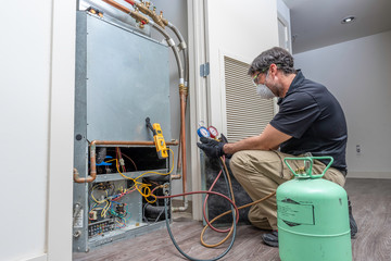 HVAC worker checking refrigerant
