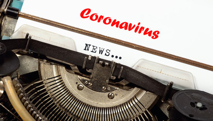 Closeup of typewriter ribbon, on a blank sheet the words coronavirus, NEWS, concept