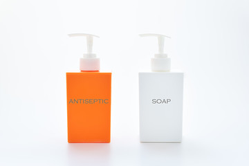 two dispensers with inscriptions - antiseptic and soap. healthcare and hygiene concept.