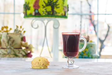 Dessert called “Lady” and mulled wine on a table in a cafe. Sweets for the guests of the cafe. Close up photo.