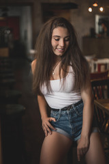 Beautiful woman posing for the camera sitting in a cafe.