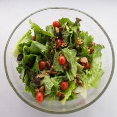 A delicious salad with lettuce, little tomatoes, nuts and sesame seeds