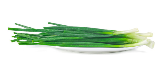 Green onion on the plate isolated on white