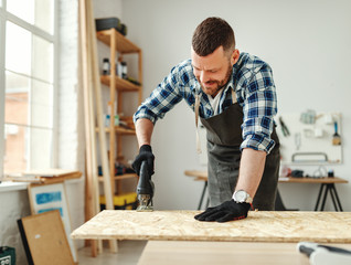 young male carpenter working in  workshop.