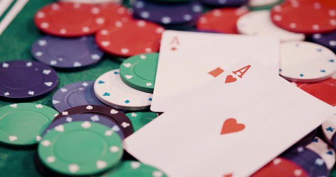 Close up of pocket rockets two aces got thrown a heap of poker chips shot in 4k super slow motion