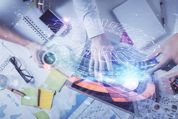 Double exposure of man's hands typing over computer keyboard and data theme hologram drawing. Top view. Technology concept.