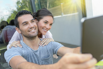 Couple in video call with a tablet   outdoors