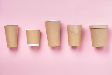 Five eco-friennly containers of similar enough shape over pink
