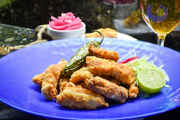 Fish fry served with cabbage salad and lemon.