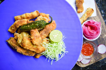 Fish fry served with cabbage salad and lemon.