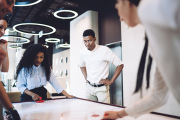 Focused colleagues playing table game at workplace