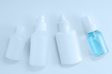 Closeup of four hand sanitizers in plastic bottle on a white background.