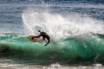 Man Creates Spray Skimboarding Wave in Beach Surf - 336535125