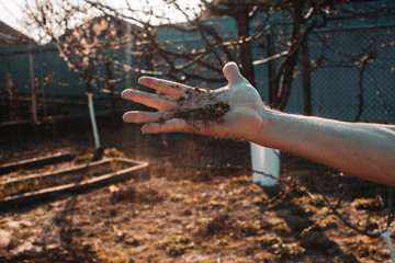 Soil, cultivated dirt, earth, ground, brown land background. Organic gardening, agriculture. Nature closeup. Environmental texture, pattern. Mud on field.