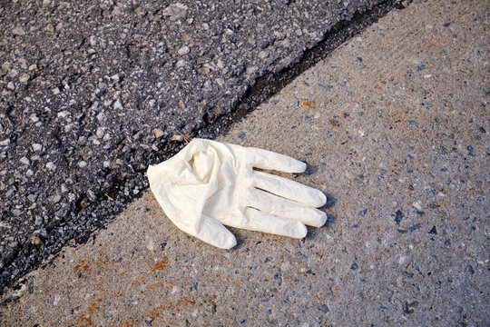 Discarded Protective Glove On The Pavement In Montreal, During The Covid 19 Lockdown