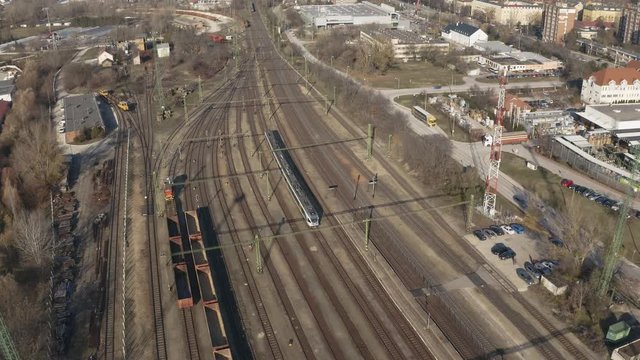 Many railway tracks of a station with passanger train arriving to the town of Tatabanya