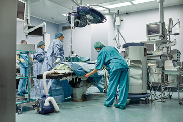 The medical team is preparing the operating room for a complex operation. Modern medicine. A team of professionals