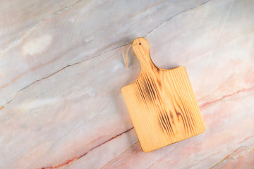 Wooden cutting board on a gray marble background