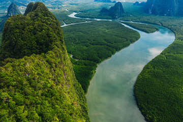 Aerial scenery view of mangroves forest, river canals and mountains. Bird's eye view of beautiful panoramic nature landscape of tropical water jungle on Ao Phang Nga bay National Park, Thailand