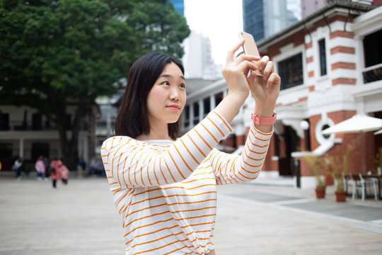 Amazed Asian tourist taking pictures
