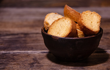 Appetizing homemade crackers for tea on a wooden table in a ceramic bowl.