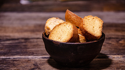 Appetizing homemade crackers for tea on a wooden table in a ceramic bowl.