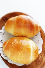 Homemade butter roll bread on wooden plate