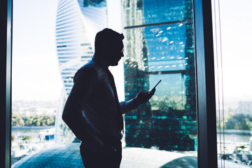 Executive businessman using phone at work space