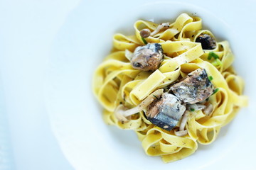 Italian food, sardines and fettuccine pasta
